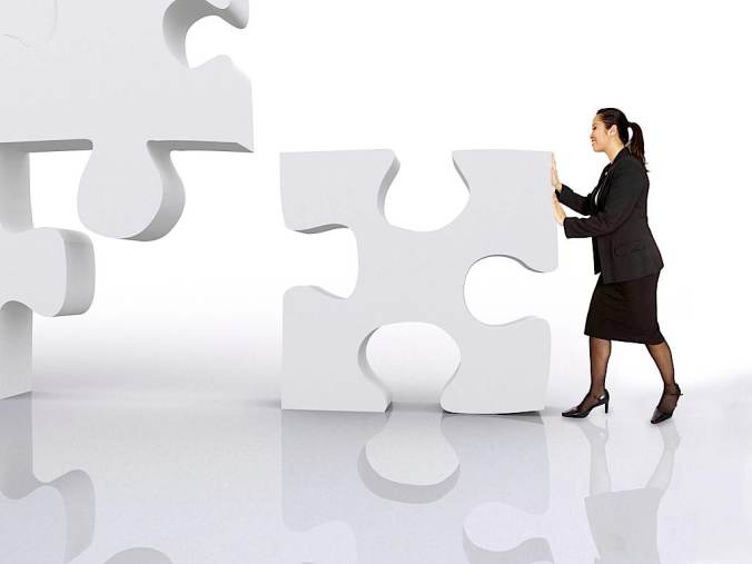 asian business woman building a puzzle over a white background